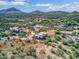 Aerial view of a single-story home with desert landscaping and mountain views at 44811 N 12Th St, New River, AZ 85087