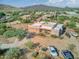 Aerial view of stucco home with flat roof, two-car garage, and desert landscaping at 44811 N 12Th St, New River, AZ 85087