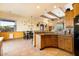Open kitchen with breakfast bar and wood cabinets at 44811 N 12Th St, New River, AZ 85087
