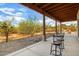 Covered patio with two barstools and desert views at 44811 N 12Th St, New River, AZ 85087