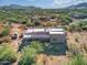 Aerial view of stucco home with flat roof, covered patio, and desert landscaping at 44811 N 12Th St, New River, AZ 85087