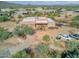 Aerial view of a stucco home with a flat roof, two-car garage, and desert landscaping at 44811 N 12Th St, New River, AZ 85087