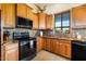 Kitchen with granite countertops and wood cabinets at 44811 N 12Th St, New River, AZ 85087