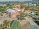 Aerial view of stucco home with flat roof, two-car garage, and desert landscaping at 44811 N 12Th St, New River, AZ 85087