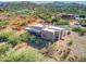 Aerial view of stucco home with flat roof, covered patio, and desert landscaping at 44811 N 12Th St, New River, AZ 85087
