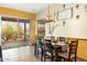 Bright dining room with a table for six and desert views at 44811 N 12Th St, New River, AZ 85087