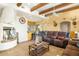 Living room featuring a fireplace, wood beams, and comfortable furnishings at 44811 N 12Th St, New River, AZ 85087