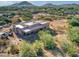 Aerial view of stucco home with flat roof, covered patio, and desert landscaping at 44811 N 12Th St, New River, AZ 85087