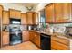 Kitchen with granite countertops and wood cabinets at 44811 N 12Th St, New River, AZ 85087