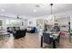 Open living room and kitchen with modern light fixtures and tile floors at 4823 S 117Th Ave, Avondale, AZ 85323