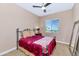 Cozy bedroom with a full-size bed, window seating, and mirror at 3730 E Cat Balue Dr, Phoenix, AZ 85050