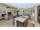 Open floor plan features a kitchen island, Gathering room with fireplace, and access to backyard at 3730 E Cat Balue Dr, Phoenix, AZ 85050