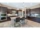 Gourmet kitchen boasts dark cabinetry, stainless steel appliances, and granite countertops at 3730 E Cat Balue Dr, Phoenix, AZ 85050