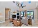 Open living area with a fireplace, access to the backyard, and views of the pool at 3730 E Cat Balue Dr, Phoenix, AZ 85050