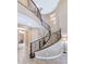 Elegant curved staircase with wrought iron railing at 3730 E Cat Balue Dr, Phoenix, AZ 85050