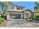 Two-story house with stone accents, a large garage, and mature landscaping at 3730 E Cat Balue Dr, Phoenix, AZ 85050