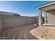 Landscaped backyard with block wall and patio at 16021 W Hackamore Dr, Surprise, AZ 85387