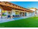 Spacious backyard patio with covered seating area, artificial turf, and a view at 4333 E Mcdonald Dr, Phoenix, AZ 85018
