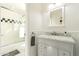 Bathroom with shower/tub combo, vanity, and white tile at 4333 E Mcdonald Dr, Phoenix, AZ 85018