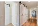 Long hallway with hardwood floors and barn-style doors at 4333 E Mcdonald Dr, Phoenix, AZ 85018
