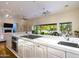 Open concept kitchen with island, marble countertops, and views of the backyard at 4333 E Mcdonald Dr, Phoenix, AZ 85018