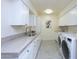 Bright laundry room with white cabinets and marble countertops at 4333 E Mcdonald Dr, Phoenix, AZ 85018