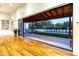Gathering room with hardwood floors and sliding doors opening to a covered patio and pool at 4333 E Mcdonald Dr, Phoenix, AZ 85018