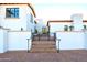 White stucco house with a courtyard and black iron gate at 4333 E Mcdonald Dr, Phoenix, AZ 85018