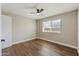 Simple bedroom with wood-look floors and a window at 14700 S Tuthill Rd, Buckeye, AZ 85326