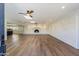 Spacious living room with hardwood floors, a fireplace, and an open floor plan at 14700 S Tuthill Rd, Buckeye, AZ 85326