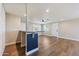 Living room with wood floors, ceiling fan, and breakfast bar at 14700 S Tuthill Rd, Buckeye, AZ 85326