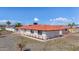 House exterior with tile roof, white walls, and desert landscaping at 14700 S Tuthill Rd, Buckeye, AZ 85326