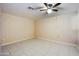 Simple spare bedroom with tile flooring and ceiling fan at 14700 S Tuthill Rd, Buckeye, AZ 85326
