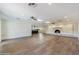 Large living room featuring hardwood floors and a brick fireplace at 14700 S Tuthill Rd, Buckeye, AZ 85326