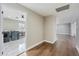 Bright hallway with wood-look floors leading to laundry and living areas at 14700 S Tuthill Rd, Buckeye, AZ 85326