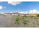 Ranch style home with gravel driveway and partial view of yard at 14700 S Tuthill Rd, Buckeye, AZ 85326