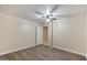 Bright bedroom featuring wood-look flooring and ceiling fan at 14700 S Tuthill Rd, Buckeye, AZ 85326