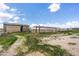 Small barn and corral structures in a rural setting at 14700 S Tuthill Rd, Buckeye, AZ 85326