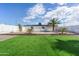 Spacious backyard oasis with artificial grass, rock landscaping and a refreshing pool at 14700 S Tuthill Rd, Buckeye, AZ 85326
