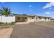 Home's front exterior with carport and desert landscaping at 14700 S Tuthill Rd, Buckeye, AZ 85326