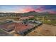 Aerial view of property at sunset, showcasing home and surrounding area at 14700 S Tuthill Rd, Buckeye, AZ 85326