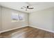 Well-lit bedroom featuring wood-look floors and a ceiling fan at 14700 S Tuthill Rd, Buckeye, AZ 85326