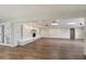 Spacious living room with white brick fireplace and wood-look floors at 14700 S Tuthill Rd, Buckeye, AZ 85326