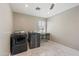 Laundry room with washer, dryer, and marble-look floors at 14700 S Tuthill Rd, Buckeye, AZ 85326
