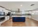 Modern kitchen with white cabinets, a large island, and stainless steel appliances at 14700 S Tuthill Rd, Buckeye, AZ 85326