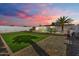 Spacious backyard oasis with a sparkling pool and grassy area at 14700 S Tuthill Rd, Buckeye, AZ 85326