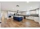 Bright kitchen featuring white shaker cabinets, a navy island, and stainless steel appliances at 14700 S Tuthill Rd, Buckeye, AZ 85326