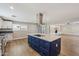 Updated kitchen with stainless steel appliances and a large blue island at 14700 S Tuthill Rd, Buckeye, AZ 85326