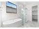 Luxurious bathroom featuring a soaking tub and walk-in shower at 682 E Aurora Dr, San Tan Valley, AZ 85140