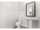 Clean and modern bathroom with pedestal sink and shower/tub combo at 682 E Aurora Dr, San Tan Valley, AZ 85140